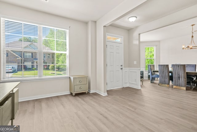 15 Manas Ct, Covington, GA 30016 - foyer entrance featuring baseboards, light wood-type flooring, and a notable chandelier