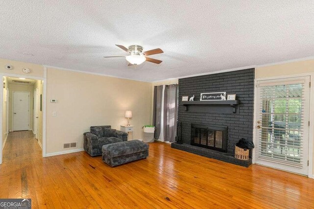 4393 Housworth Dr, Stonecrest, GA 30038 - living area featuring a textured ceiling, visible vents, ceiling fan, and hardwood / wood-style flooring