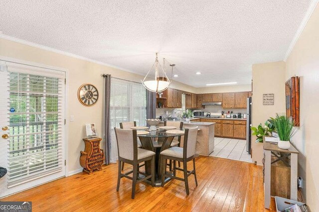 4393 Housworth Dr, Stonecrest, GA 30038 - dining area with crown molding, a textured ceiling, and light wood-type flooring