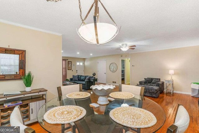 4393 Housworth Dr, Stonecrest, GA 30038 - dining space featuring a textured ceiling, a ceiling fan, and wood finished floors