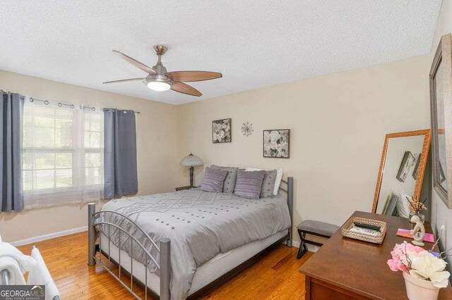 4393 Housworth Dr, Stonecrest, GA 30038 - bedroom with light wood-type flooring, a ceiling fan, and a textured ceiling