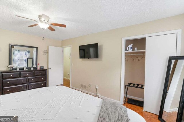 4393 Housworth Dr, Stonecrest, GA 30038 - bedroom with a textured ceiling, visible vents, baseboards, a closet, and wood finished floors