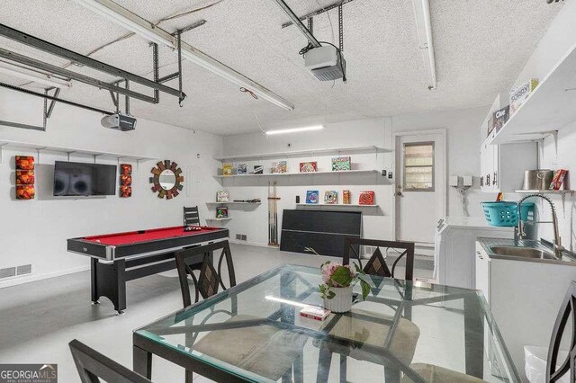 4393 Housworth Dr, Stonecrest, GA 30038 - interior space with a textured ceiling, a sink, concrete floors, visible vents, and a garage