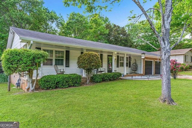 4393 Housworth Dr, Stonecrest, GA 30038 - ranch-style home featuring a porch, a front yard, driveway, and a garage