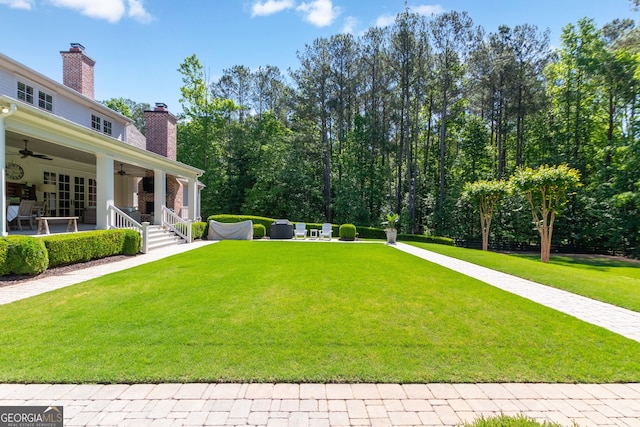 view of yard featuring a ceiling fan
