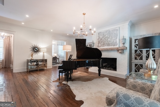 sitting room with crown molding, an inviting chandelier, and wood-type flooring