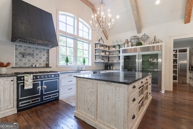 kitchen featuring dark wood-style floors, wall chimney exhaust hood, double oven range, and a chandelier