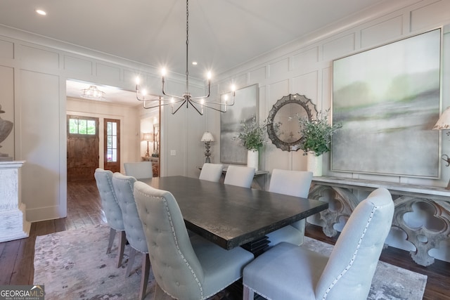 dining area with recessed lighting, an inviting chandelier, a decorative wall, hardwood / wood-style flooring, and crown molding