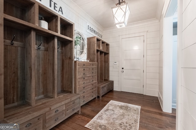 mudroom with crown molding and dark wood finished floors