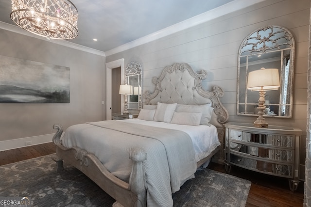 bedroom featuring ornamental molding, an inviting chandelier, wood finished floors, and baseboards