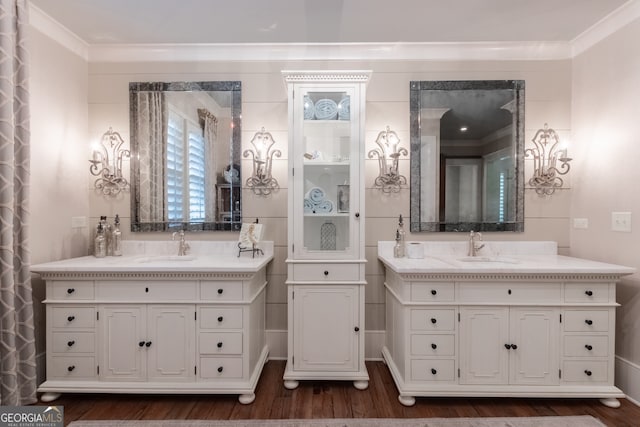 full bath with two vanities, wood finished floors, and a sink