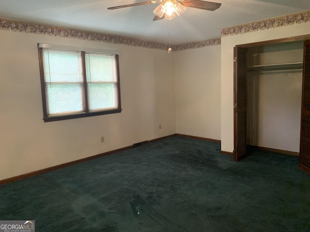96 Glencrest Dr, Toccoa, GA 30577 - unfurnished bedroom featuring a closet, ceiling fan, dark colored carpet, and baseboards