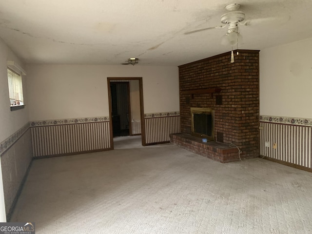 96 Glencrest Dr, Toccoa, GA 30577 - unfurnished living room featuring a wainscoted wall, a ceiling fan, carpet, and a fireplace