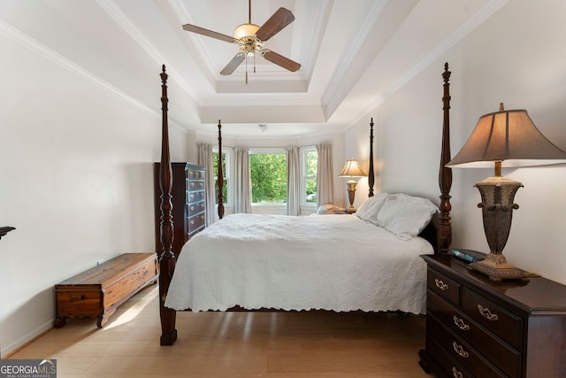 601 Ashley Forest Dr NW, Acworth, GA 30102 - bedroom with ornamental molding, a tray ceiling, light wood-type flooring, a ceiling fan, and baseboards