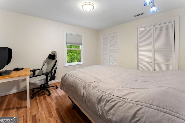 601 Ashley Forest Dr NW, Acworth, GA 30102 - bedroom featuring wood finished floors, multiple closets, a desk, and baseboards