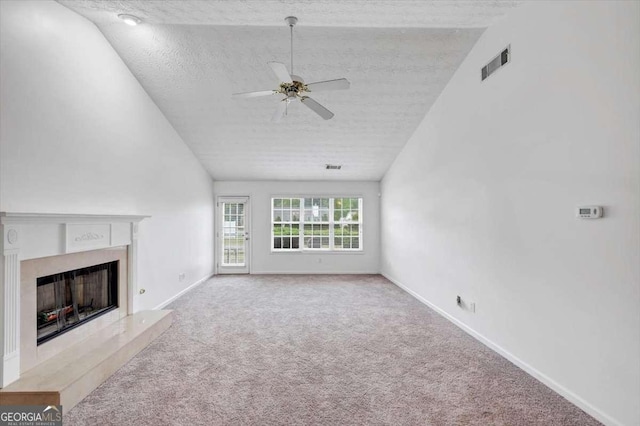 unfurnished living room featuring carpet flooring, a premium fireplace, a ceiling fan, visible vents, and baseboards