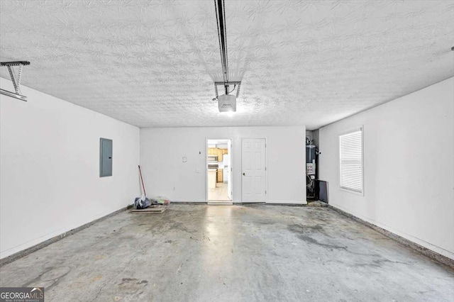 garage featuring baseboards, gas water heater, and electric panel