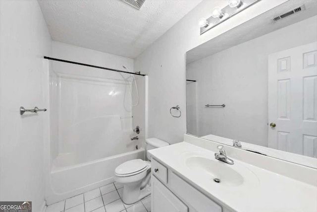 full bathroom with vanity, tile patterned floors, toilet, visible vents, and a textured ceiling