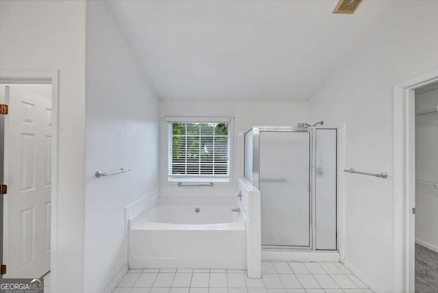 full bathroom with a spacious closet, tile patterned flooring, a shower stall, visible vents, and a garden tub