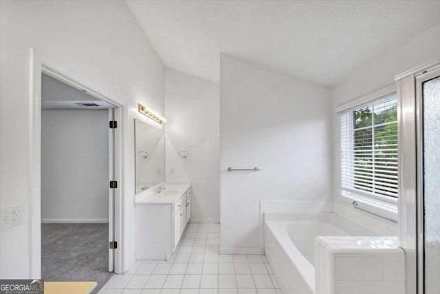 full bath featuring visible vents, baseboards, a bath, vaulted ceiling, and vanity