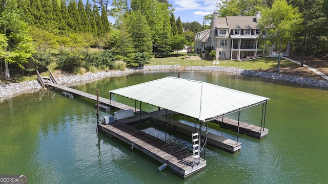 dock area with a lawn, a water view, and boat lift