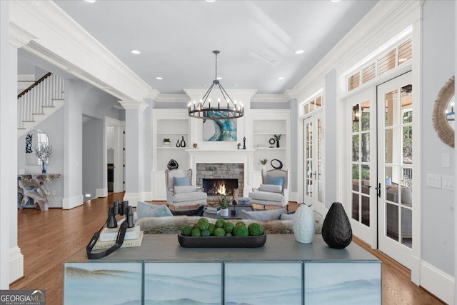 living area featuring ornamental molding, french doors, wood finished floors, and baseboards