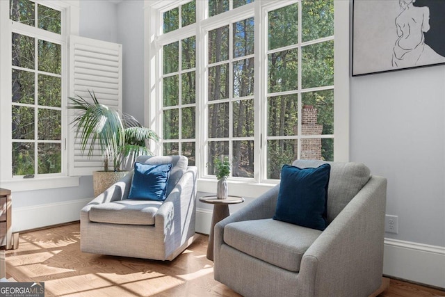 living area with a wealth of natural light and wood finished floors