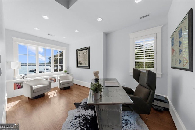 home office with recessed lighting, visible vents, wood finished floors, and baseboards