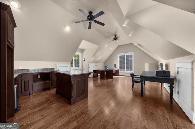 home office featuring dark wood-type flooring, a ceiling fan, and vaulted ceiling