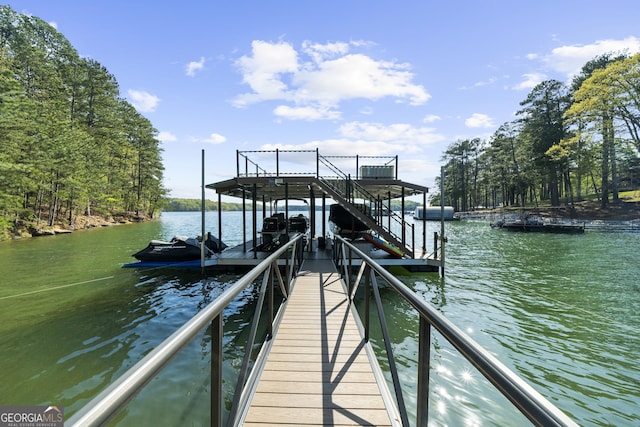 dock area with a water view and boat lift