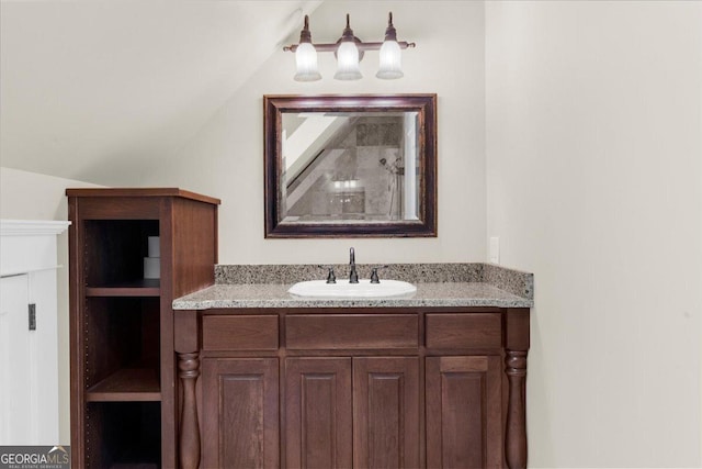 bathroom featuring vanity and vaulted ceiling