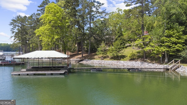 dock area with a water view and boat lift