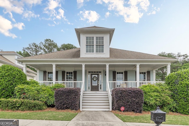 bungalow with a porch and a shingled roof