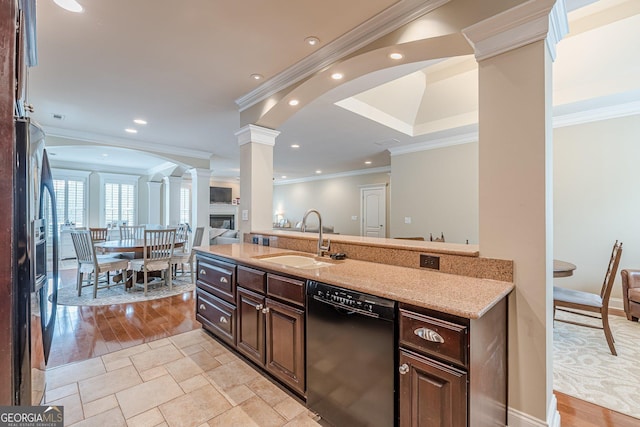 kitchen featuring ornate columns, ornamental molding, black dishwasher, and a sink