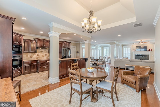 dining space with recessed lighting, decorative columns, ornamental molding, light wood finished floors, and visible vents