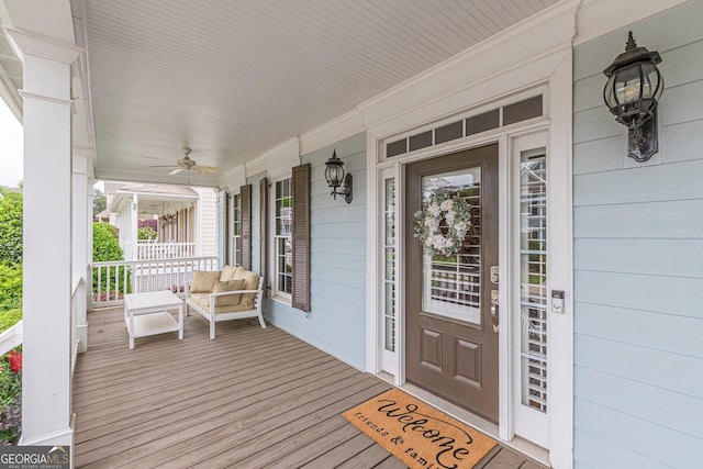 doorway to property with ceiling fan and a porch