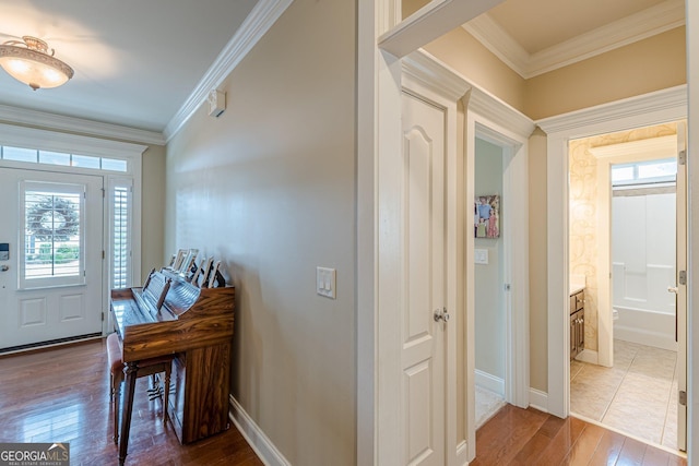 foyer entrance with baseboards, crown molding, and dark wood-type flooring