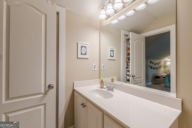 bathroom featuring lofted ceiling and vanity