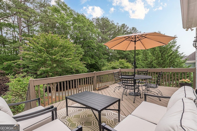 deck with outdoor dining area