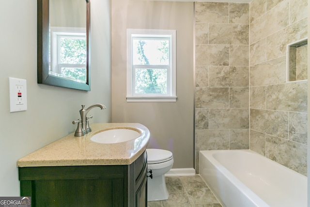 bathroom with toilet, baseboards, plenty of natural light, and vanity