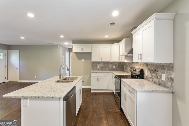 kitchen featuring wall chimney range hood, appliances with stainless steel finishes, a sink, dark wood finished floors, and visible vents