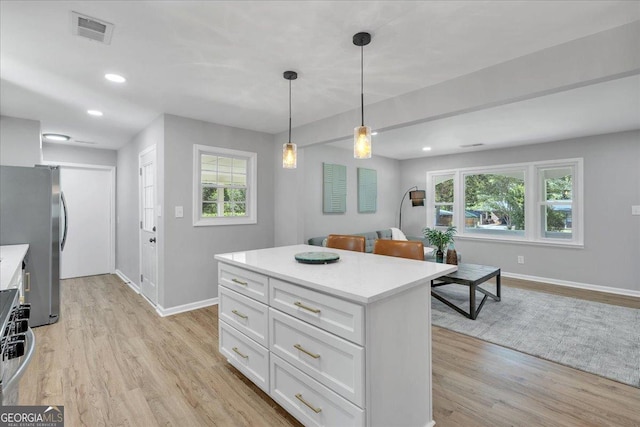 3951 Lindley Dr, Powder Springs, GA 30127 - kitchen with baseboards, freestanding refrigerator, light countertops, healthy amount of natural light, and recessed lighting