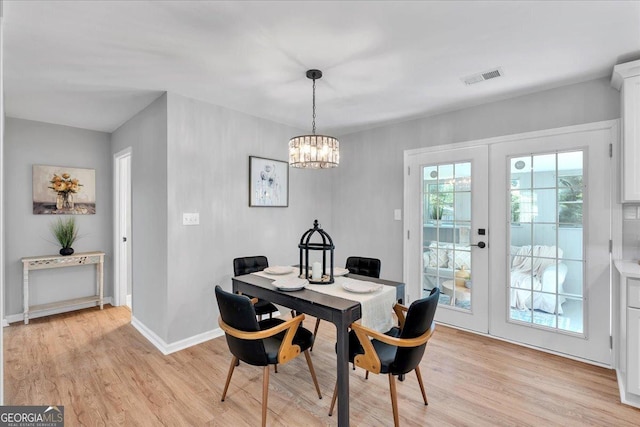 3951 Lindley Dr, Powder Springs, GA 30127 - dining space featuring light wood-type flooring, a chandelier, french doors, baseboards, and an office area
