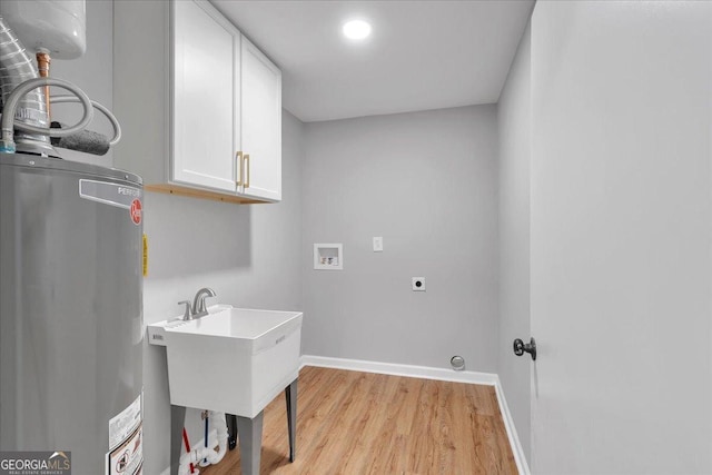 3951 Lindley Dr, Powder Springs, GA 30127 - clothes washing area featuring cabinet space, gas water heater, washer hookup, electric dryer hookup, and light wood-type flooring