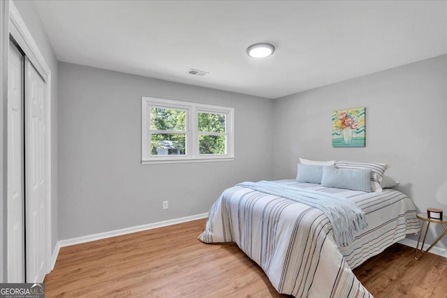3951 Lindley Dr, Powder Springs, GA 30127 - bedroom with baseboards, light wood-style floors, and a closet