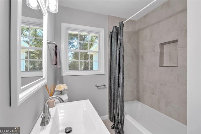 3951 Lindley Dr, Powder Springs, GA 30127 - bathroom with a sink and shower / bathtub combination with curtain