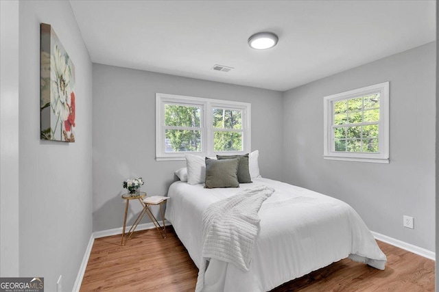 3951 Lindley Dr, Powder Springs, GA 30127 - bedroom with multiple windows, baseboards, and wood finished floors