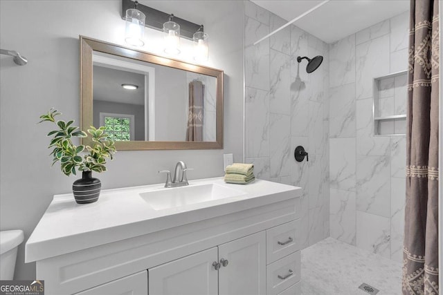 3951 Lindley Dr, Powder Springs, GA 30127 - bathroom featuring tiled shower, vanity, and toilet