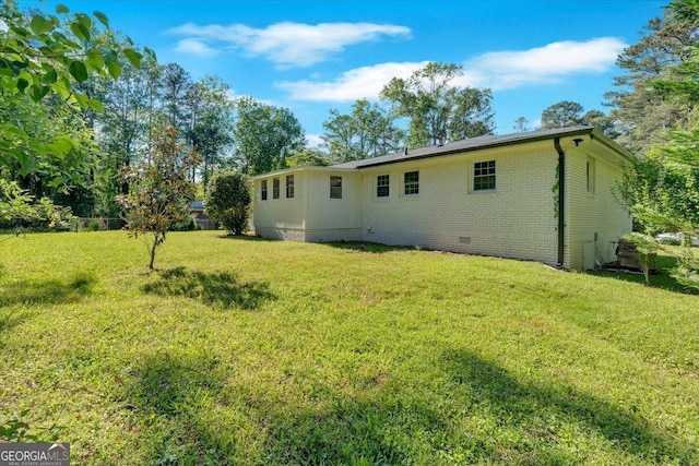 3951 Lindley Dr, Powder Springs, GA 30127 - rear view of house featuring crawl space, a yard, and brick siding
