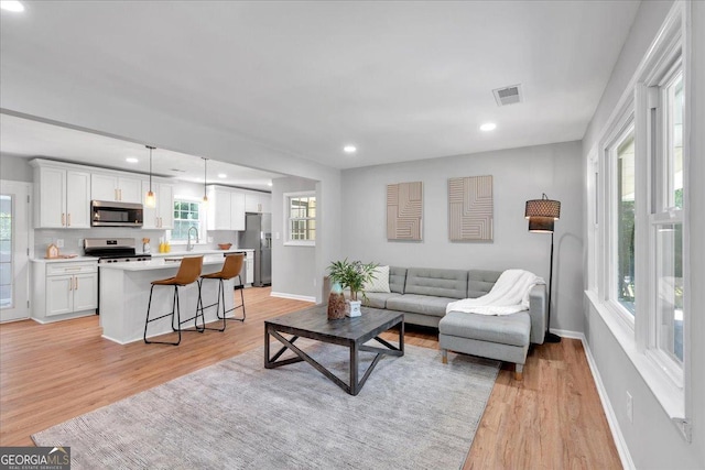 3951 Lindley Dr, Powder Springs, GA 30127 - living room with light wood-style flooring, baseboards, and recessed lighting